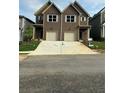 Two story townhome featuring a brown exterior, white trim, and attached garages at 3102-B Brownstone Se Ln, Atlanta, GA 30354