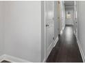 Hallway features neutral paint, white trim, doors and dark hardwood flooring at 3102-B Brownstone Se Ln, Atlanta, GA 30354