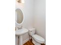 Cozy half bath featuring white fixtures and hardwood flooring at 3330 Madison St, Atlanta, GA 30337