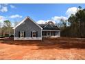 Newly constructed gray house with black shutters and a covered porch at 157 Golden Rd, Temple, GA 30179