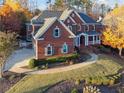 Elegant brick home with well-maintained landscaping, a walkway, and a spacious driveway at 2195 Lake Shore Lndg, Alpharetta, GA 30005