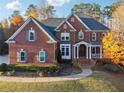 Charming brick home with manicured front lawn and inviting entryway showcasing classic design at 2195 Lake Shore Lndg, Alpharetta, GA 30005