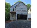 Two-story home's exterior is under construction with an attached two-car garage and gravel driveway at 1664 Crestridge Se Dr, Marietta, GA 30067