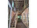 Unfinished interior showcasing exposed framing, a staircase, and natural light filtering through the windows at 1664 Crestridge Se Dr, Marietta, GA 30067