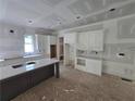 Kitchen with white cabinets, a gray island, and modern design elements at 1664 Crestridge Se Dr, Marietta, GA 30067