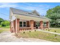 Charming brick home with a covered front porch, showcasing its architectural details at 1220 Hightower Nw Rd, Atlanta, GA 30318