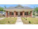Inviting brick home featuring a covered front porch and a well-maintained walkway at 1220 Hightower Nw Rd, Atlanta, GA 30318