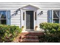 Dark-stained front door with sidelights and brick steps at 1111 Valley Ridge Se Ct, Marietta, GA 30067