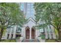Stately building entrance with large wooden doors, grand architecture, and lush landscaping at 2870 Pharr Court S Nw # 2703, Atlanta, GA 30305