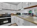 Galley kitchen with white cabinets and stainless steel appliances at 361 W Post Oak Sw Xing, Marietta, GA 30008