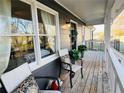 Inviting front porch with wooden deck, two chairs, and potted plants at 51 Jennifer Ln, Rydal, GA 30171