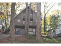 Rustic A-frame home with large deck and trees at 8441 Lake Dr, Snellville, GA 30039