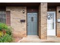 Close-up of the townhouse entry with a mailbox, an exterior light, and a wreath on the white front door at 2946 N Dekalb Dr # Apt C, Atlanta, GA 30340