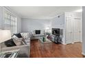 Cozy living room with modern furnishings, hardwood floors, and plenty of natural light from a large window at 2946 N Dekalb Dr # Apt C, Atlanta, GA 30340