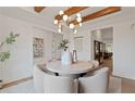 Bright dining room with modern light fixture, wood beam ceiling, and elegant decor at 2810 Herrington Dr, Cumming, GA 30041