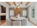Bright dining room with modern light fixture, wood beam ceiling, and elegant decor at 2810 Herrington Dr, Cumming, GA 30041