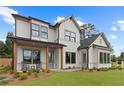 Charming two-story home featuring a welcoming front porch and attractive landscaping at 2810 Herrington Dr, Cumming, GA 30041