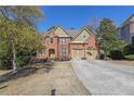 Beautiful two-story brick home with mature landscaping, double garage, and inviting curb appeal at 3423 Mulberry Lane Ct, Dacula, GA 30019