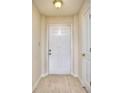 Clean, bright entryway with tile flooring, a white front door, and access to an adjoining room at 240 Renaissance Pkwy # 116, Atlanta, GA 30308