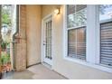 Cozy patio features concrete flooring and leads to an exterior door with large awning windows at 240 Renaissance Pkwy # 116, Atlanta, GA 30308