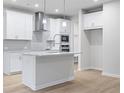 Modern kitchen with white cabinets, quartz countertops, and stainless steel appliances at 1068 Rose Dr, Marietta, GA 30060