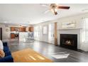 Open-concept living room featuring a fireplace, dining area, and kitchen at 6476 Snowden Dr, Atlanta, GA 30349