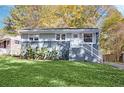 Charming single-story home boasts a well-maintained lawn and inviting front entrance with white stairs and gray accents at 2190 Lang Sw Dr, Atlanta, GA 30315