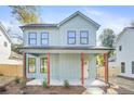 Two-story craftsman home with light green siding and a charming front porch at 2048 Chicago Nw Ave, Atlanta, GA 30314