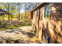 View of the home's exterior showcasing the driveway with a well-manicured lawn and lush landscaping at 4771 Cool Springs Rd, Winston, GA 30187