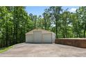 Large detached three-door garage, offering ample space for parking, storage, or a workshop area at 291 Miquel Jorge Ln, Canton, GA 30115