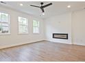 Spacious living room with hardwood floors, fireplace, and multiple windows at 717 Trevett Way, Marietta, GA 30062