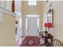 Bright entryway with hardwood floors, a rug, and a console table at 905 Fairview Club Cir, Dacula, GA 30019