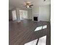 Spacious living room featuring wood-look flooring, a fireplace, and a ceiling fan at 2280 Highridge Point Dr, Lithia Springs, GA 30122