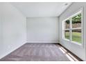 Bright bedroom with neutral walls and carpet at 4251 Matisse Ln, Fairburn, GA 30213