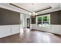 Elegant dining room with hardwood floors and wainscoting at 4251 Matisse Ln, Fairburn, GA 30213