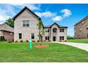 Two-story home with a large front yard and driveway at 4251 Matisse Ln, Fairburn, GA 30213