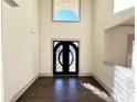 Grand foyer with a decorative black iron front door and soaring ceilings allowing ample natural light at 990 Botanica Way, Fairburn, GA 30213
