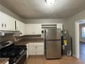 Updated kitchen features stainless steel appliances and light wood cabinets at 2053 Juanita St, Decatur, GA 30032