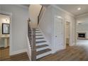 Elegant staircase with dark wood and metal accents at 4037 Andover Cir, Mcdonough, GA 30252