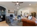 Light-filled living room with stone fireplace, hardwood floors, and stylish furniture at 13130 Providence Rd, Milton, GA 30009