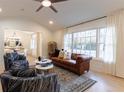 Bright living room with a comfy leather couch and large windows at 13130 Providence Rd, Milton, GA 30009