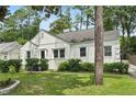 White house with a well-maintained lawn and lush landscaping at 952 Lindbergh Ne Dr, Atlanta, GA 30324