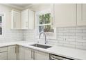 Modern kitchen featuring white cabinets, subway tile backsplash, stainless steel appliances, and a bright window at 952 Lindbergh Ne Dr, Atlanta, GA 30324