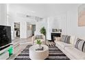 Open living room with plush seating, fireplace and modern finishes at 4880 Twin Lakes Trl # 11, Atlanta, GA 30360