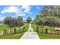 Long driveway leading to a charming two-story home at 2054 Cook Rd, Oxford, GA 30054