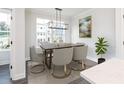 A dining room with modern chandelier with bright natural light entering from a large window at 365 Skylar Se Way, Atlanta, GA 30315
