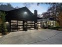 Spacious three-car garage with modern glass doors, providing ample parking and storage at 2716 Ridgewood Nw Rd, Atlanta, GA 30327