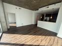 Open living space with wood floors seamlessly transitioning into a modern kitchen with stainless steel appliances at 855 Peachtree St # 2205, Atlanta, GA 30308