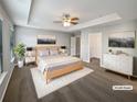 Spacious main bedroom with tray ceiling, carpet flooring, and ensuite bathroom at 3279 Wild Basil Ln, Buford, GA 30519
