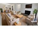 Bright living room featuring a cozy fireplace, neutral colors and stylish furnishings at 504 Vicksburg Pl, Atlanta, GA 30350